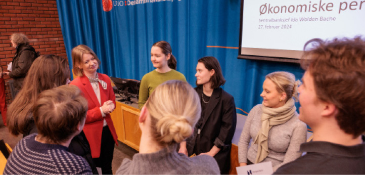 A group of women standing talking to each other