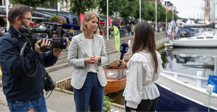 Ida Wolden Bache being interviewed by TV2 on the quay in Arendal