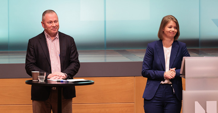 Nicolai Tangen and Ida Wolden Bache standing at a lectern in front of an audience